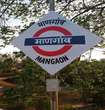 Mangaon_a red and white sign on a pole